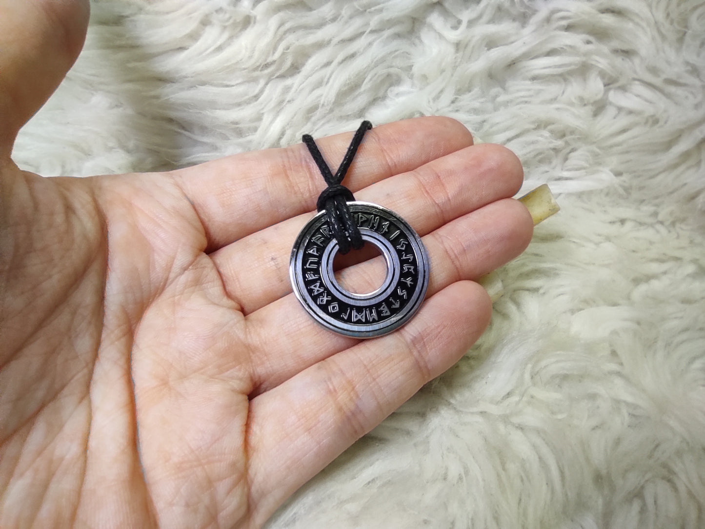 Silver round amulet with runes