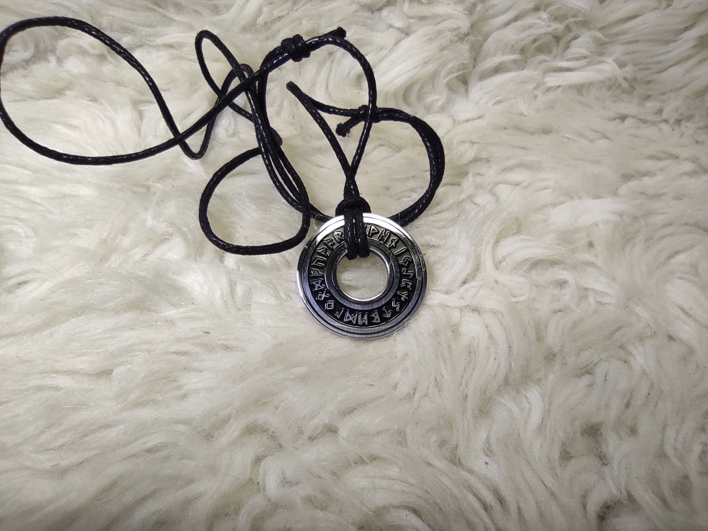 Silver round amulet with runes