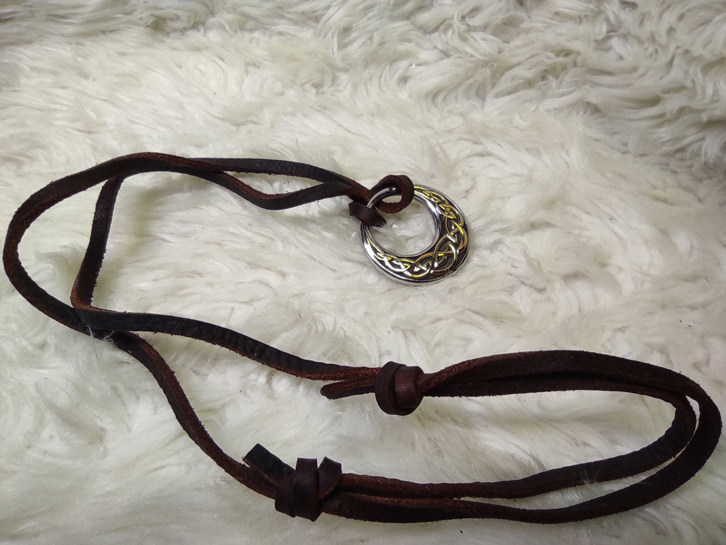 Celtic knot in a circular design on a leather cord